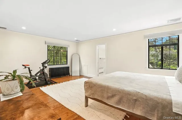 a spacious bedroom with a large bed and a large window