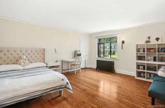 a bedroom with a bed a table and chair