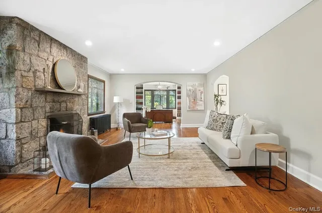 a living room with furniture a fireplace and a large window