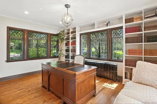 a work room with furniture and large windows