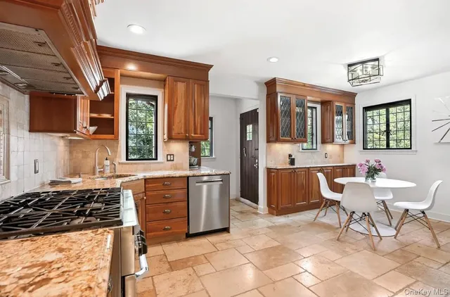 a kitchen with stainless steel appliances a stove a sink dishwasher and a refrigerator