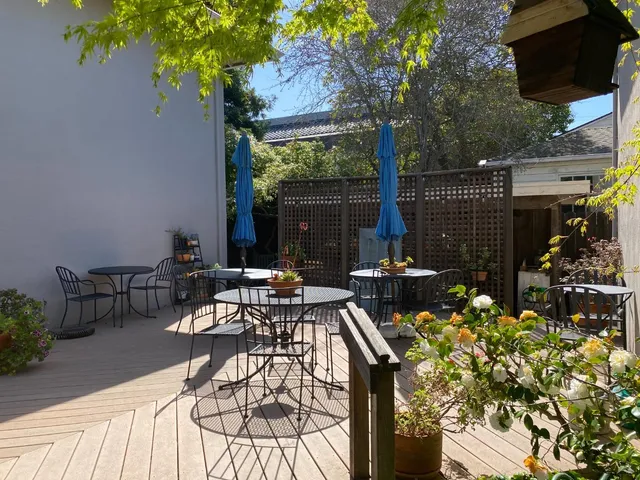 a view of a patio with table and chairs and potted plants