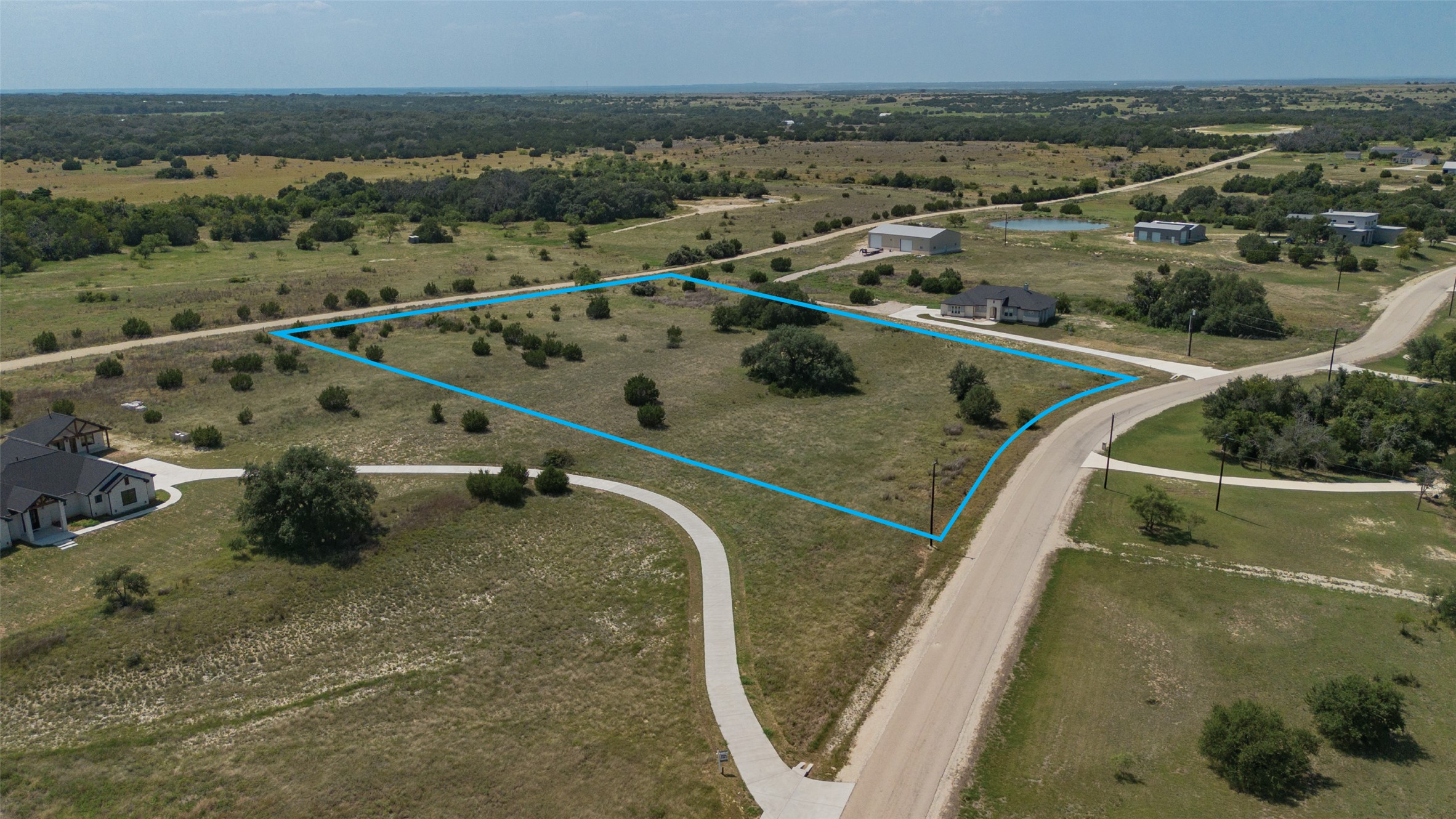 Lot 3 Cloudwood Ranch Road Briggs, TX 78608 - Photo 12 of 13 Vast, ready-to-build lot with partial clearing, offering scenic views and abundant green space.