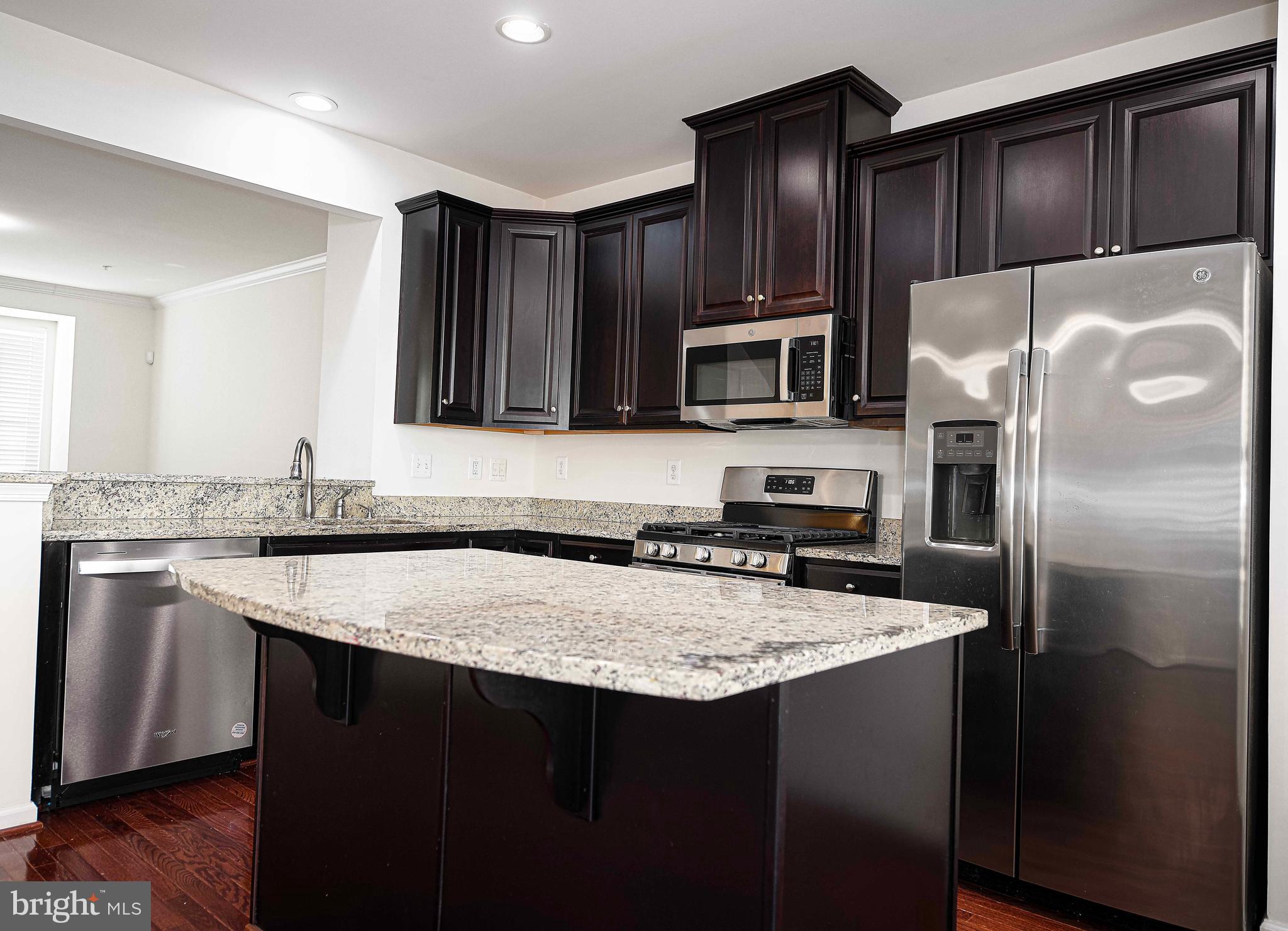1032 Ramble Run Road Baltimore, MD 21220 - Photo 12 of 46 a kitchen with kitchen island granite countertop a sink stove and refrigerator