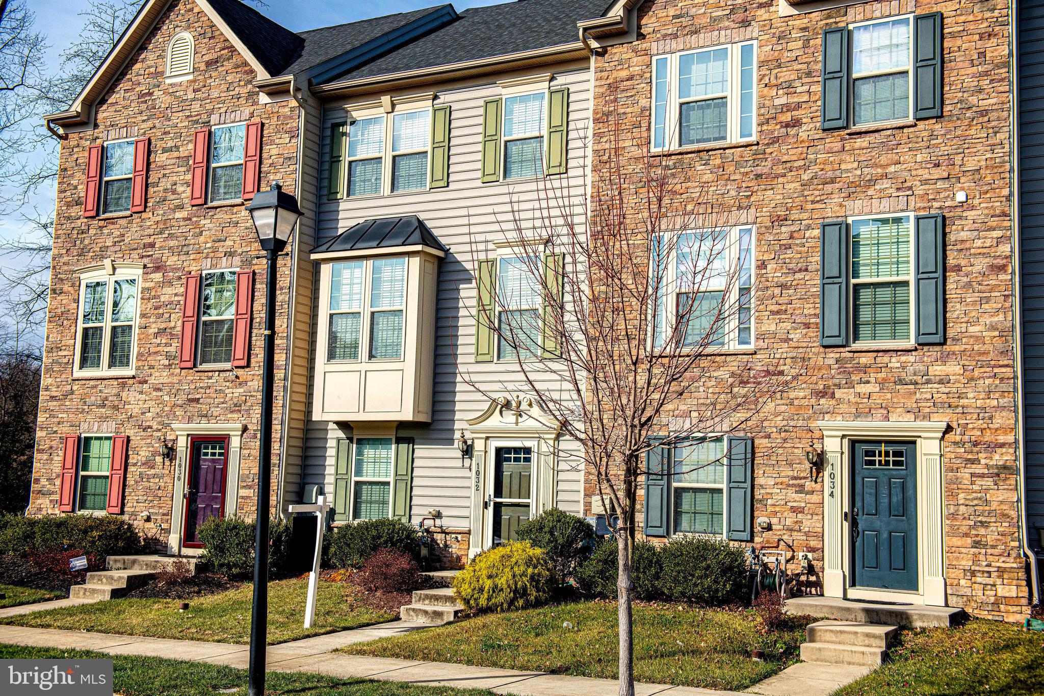 1032 Ramble Run Road Baltimore, MD 21220 - Photo 3 of 46 front view of a brick house with a fountain