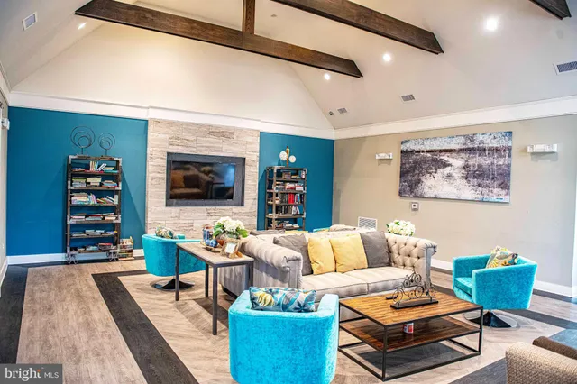 a living room with furniture fireplace and flat screen tv