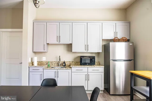 a living room with furniture a rug and a flat screen tv