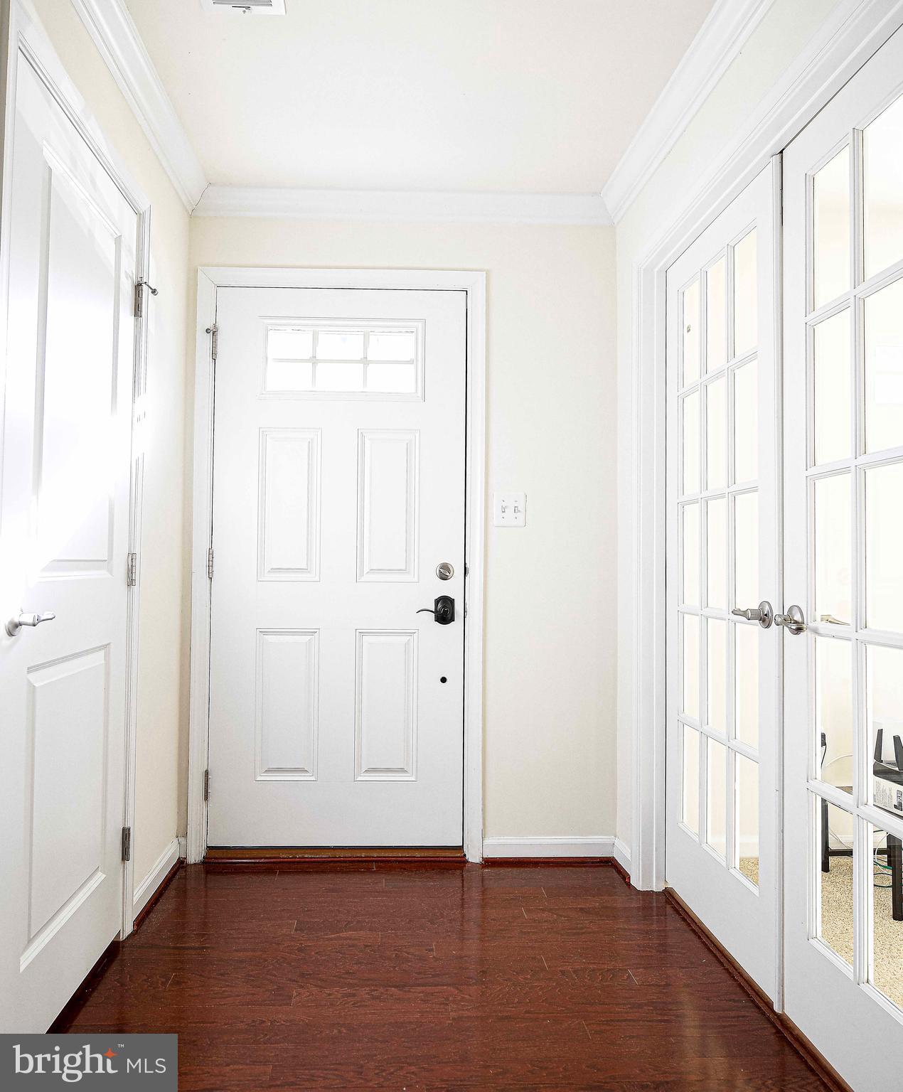 1032 Ramble Run Road Baltimore, MD 21220 - Photo 5 of 46 an empty room with wooden floor and windows