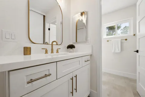 a bathroom with a double vanity sink mirror and