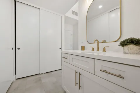 a bathroom with a double vanity sink mirror and