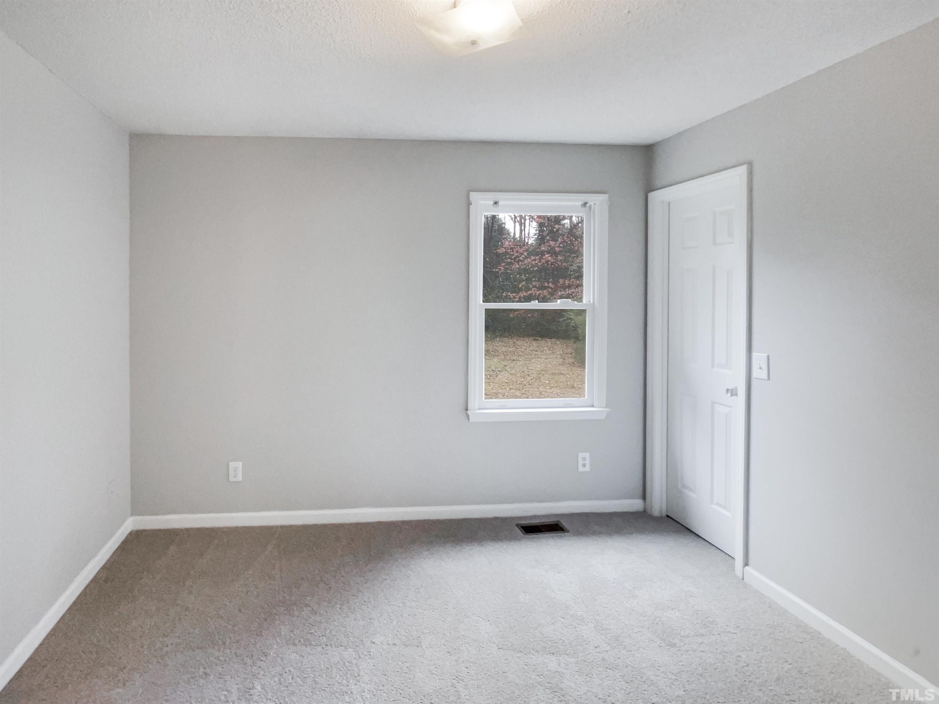 1459 Atkins Road Fuquay-Varina, NC 27526 - Photo 14 of 21 an empty room with a window