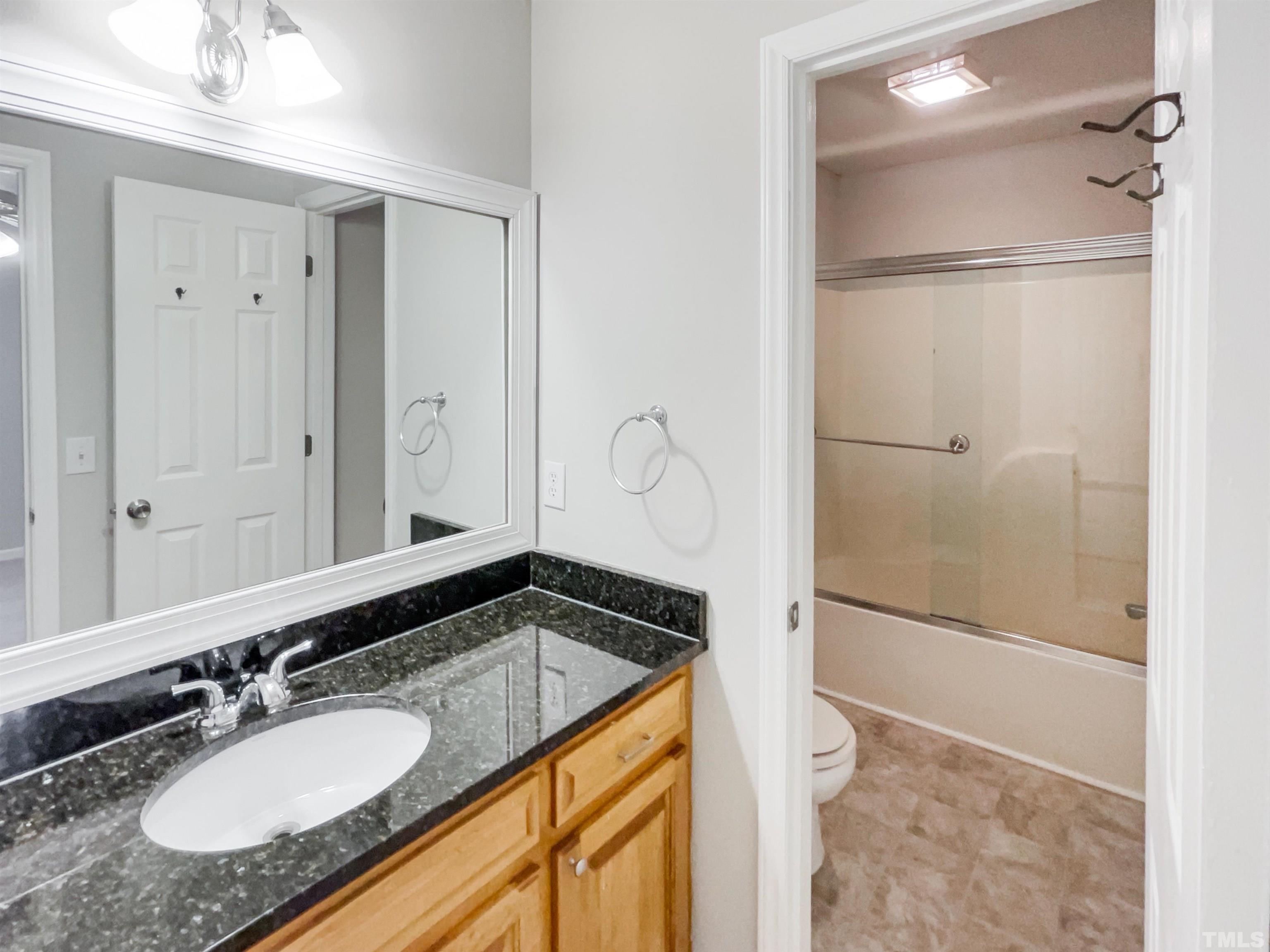 1459 Atkins Road Fuquay-Varina, NC 27526 - Photo 15 of 21 a bathroom with a granite countertop sink mirror and shower