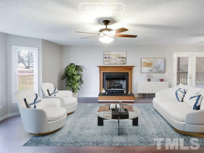1459 Atkins Road Fuquay-Varina, NC 27526 - Photo 2 of 21 a living room with furniture and a fireplace