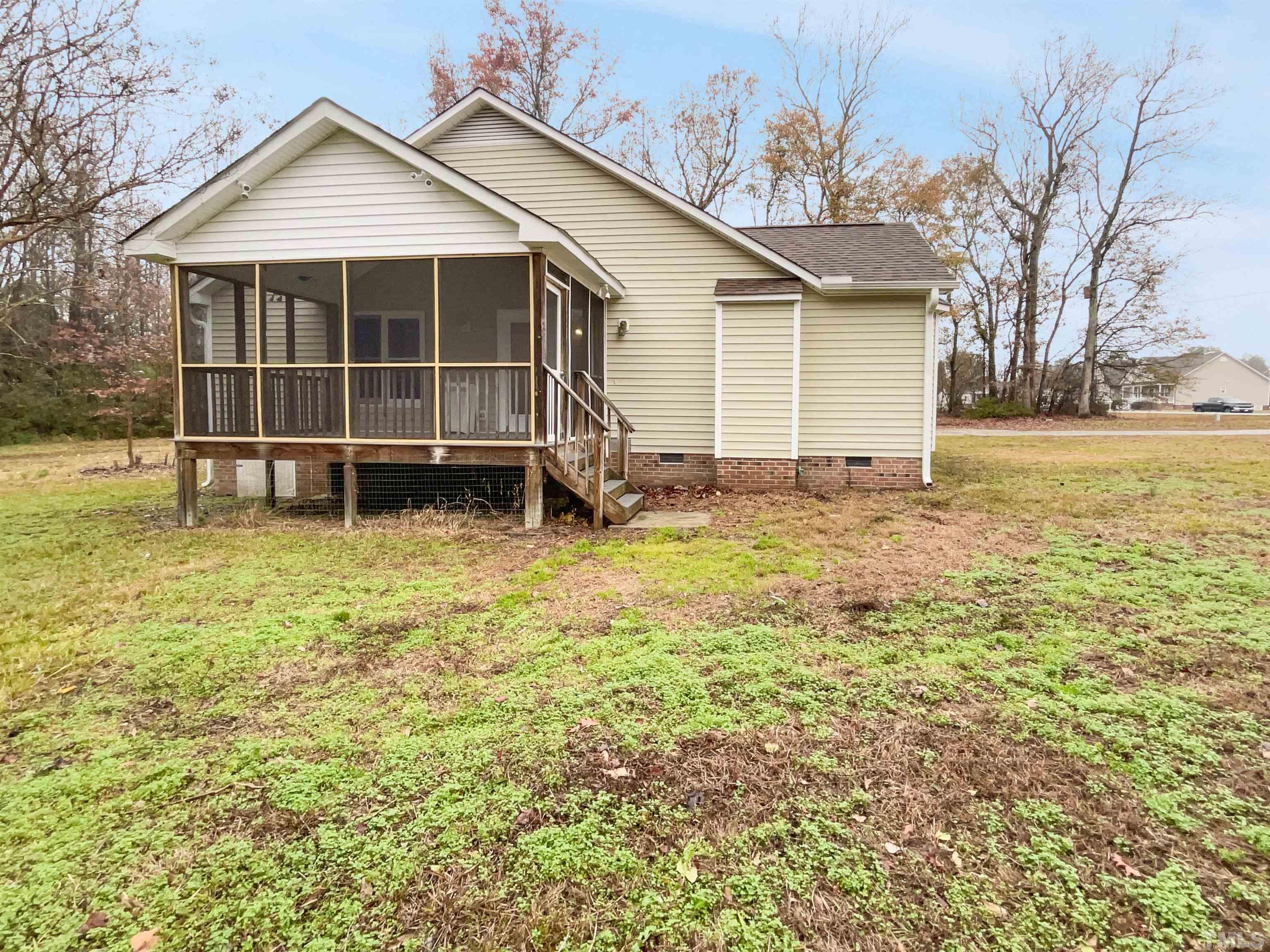 1459 Atkins Road Fuquay-Varina, NC 27526 - Photo 21 of 21 a view of a house with a yard