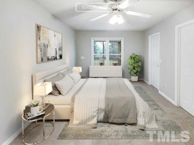 1459 Atkins Road Fuquay-Varina, NC 27526 - Photo 3 of 21 a bedroom with a bed and a chandelier