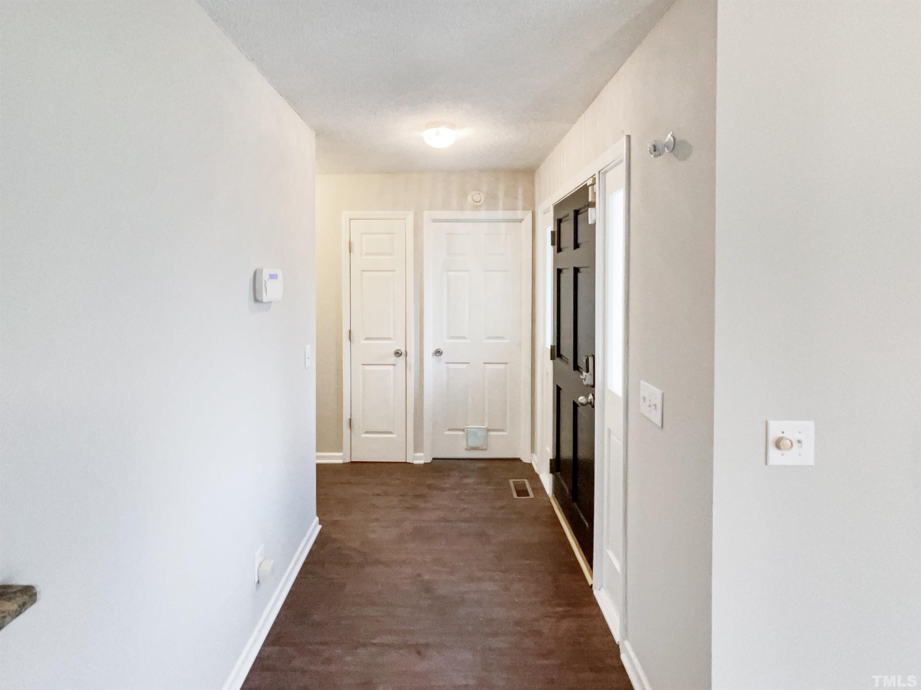 1459 Atkins Road Fuquay-Varina, NC 27526 - Photo 5 of 21 a view of a hallway with wooden floor and closet