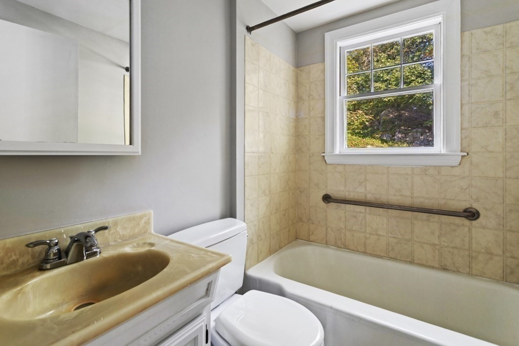 82 Spring Street Stoneham, MA 02180 - Photo 17 of 34 a bathroom with a sink a toilet and bathtub