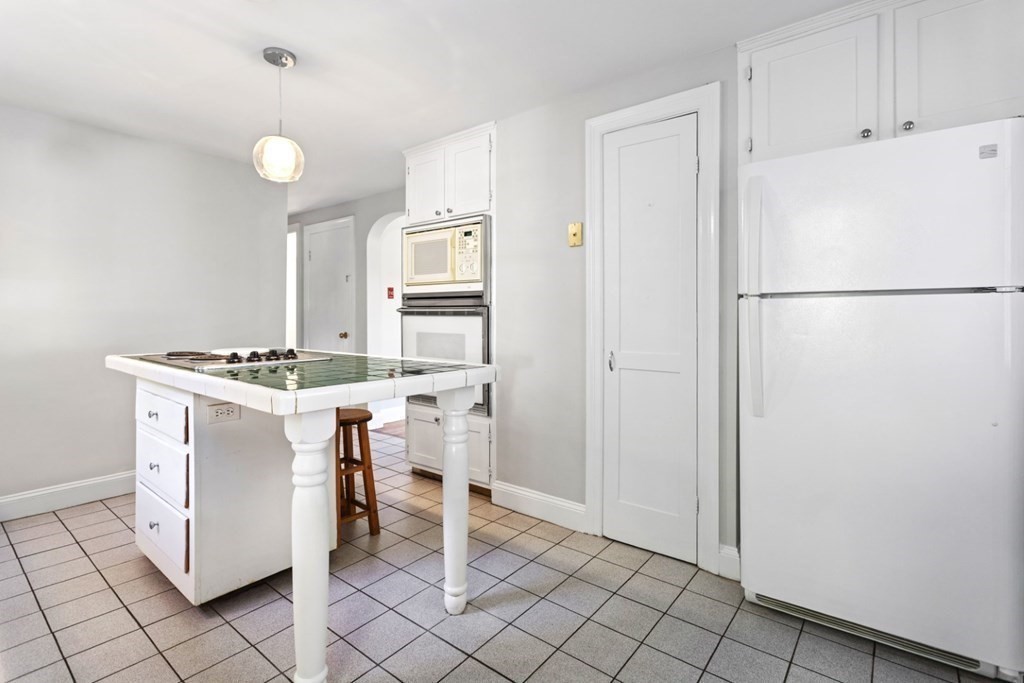 82 Spring Street Stoneham, MA 02180 - Photo 9 of 34 a view of kitchen with furniture and refrigerator