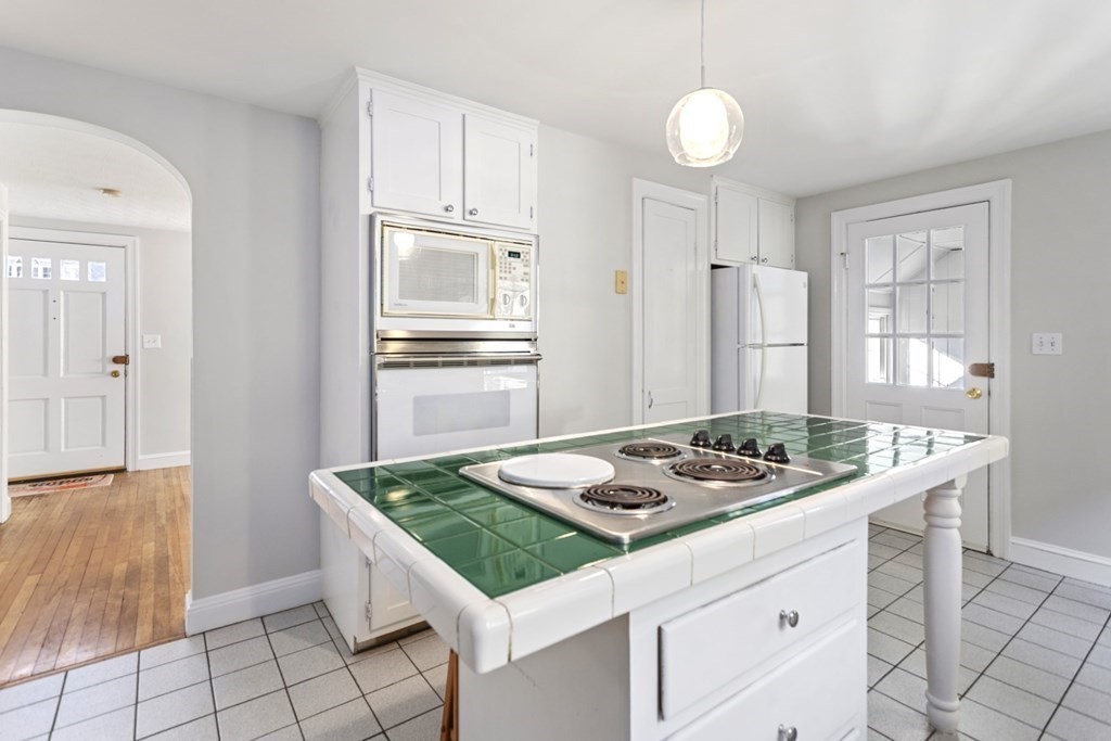 82 Spring Street Stoneham, MA 02180 - Photo 10 of 34 a kitchen that has a sink and a stove in it