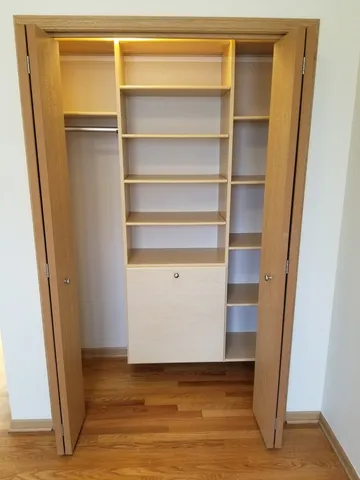 a view of walk in closet with empty racks