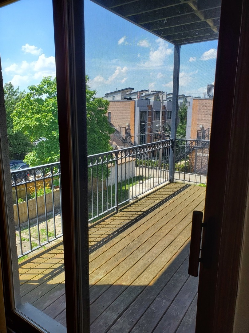 2226 West Monroe Street, Unit 3 Chicago, IL 60612 - Photo 6 of 17 a view of a balcony with floor to ceiling window wooden floor with wooden floor