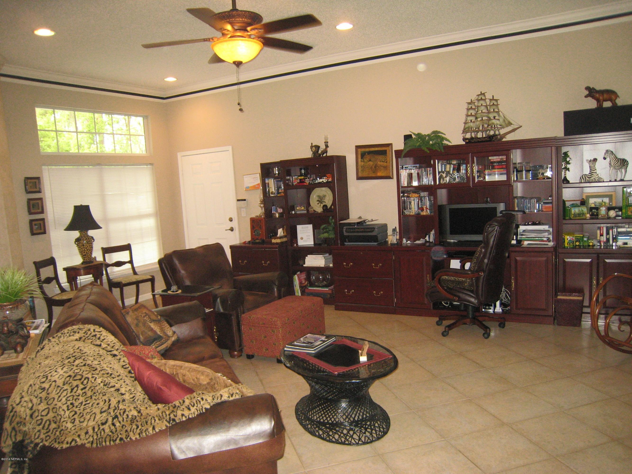 11636 Mandarin Road Jacksonville, FL 32223 - Photo 11 of 41 a living room with furniture and a flat screen tv