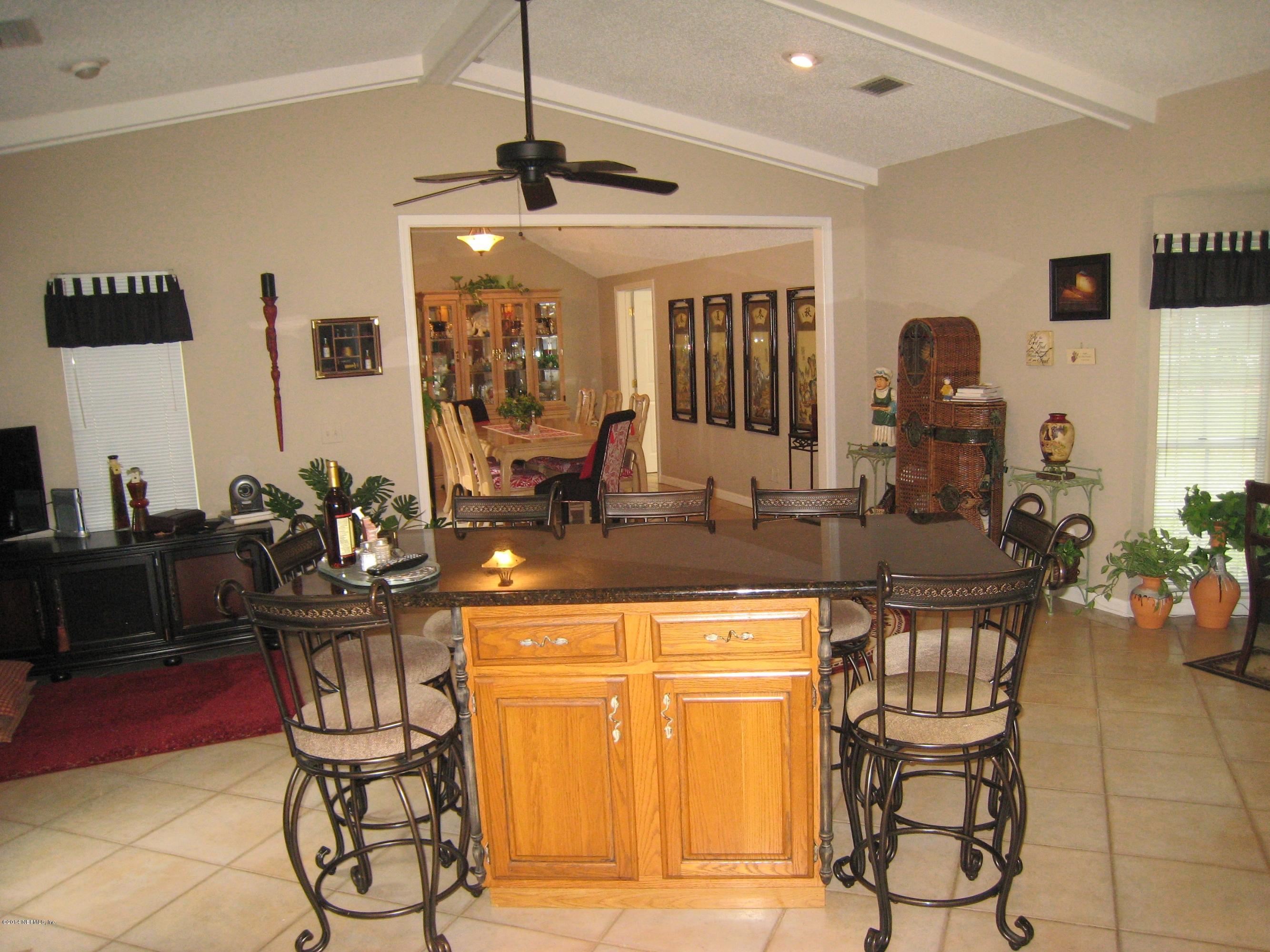 11636 Mandarin Road Jacksonville, FL 32223 - Photo 16 of 41 a view of a kitchen with dining table and chairs