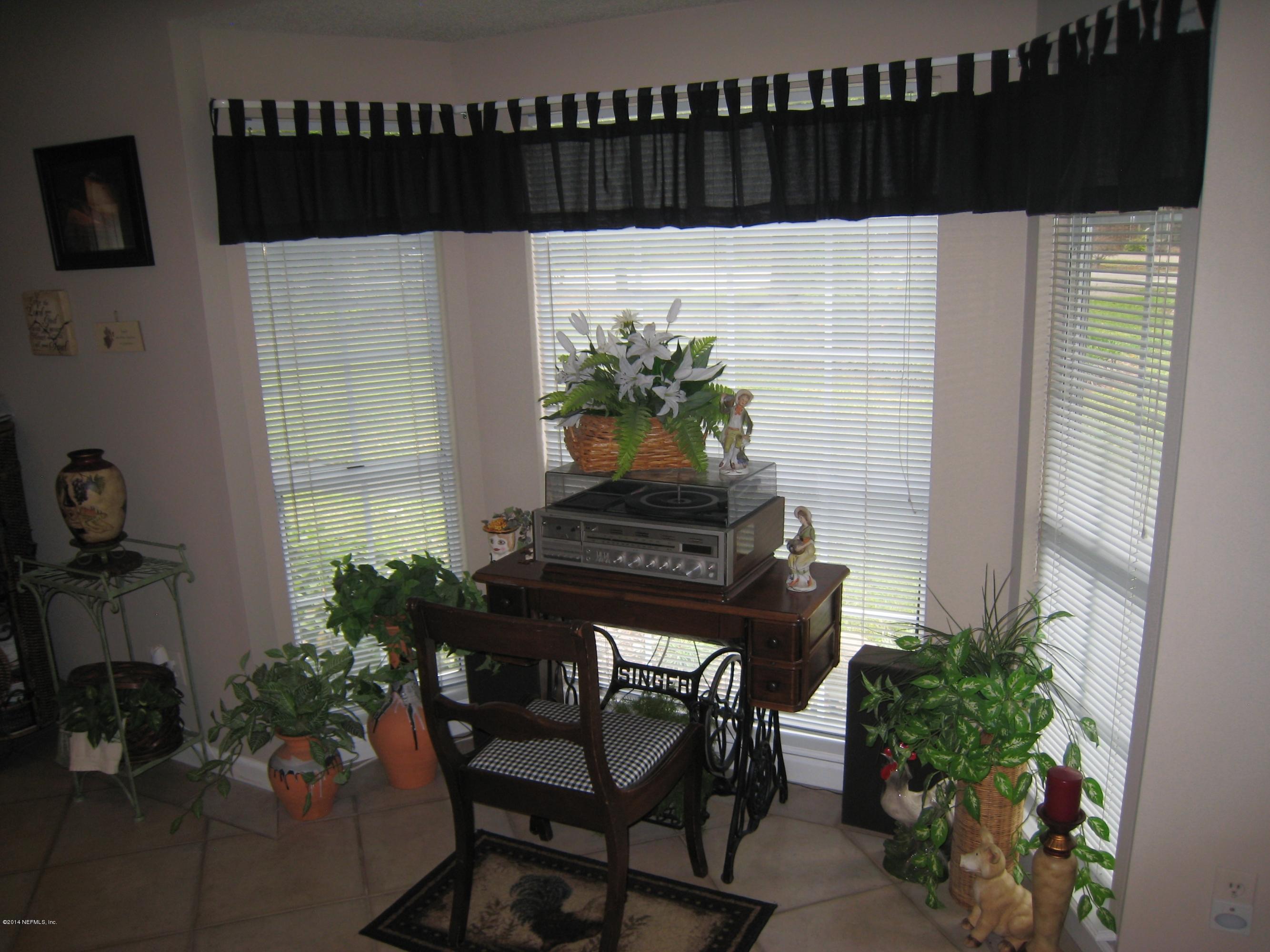 11636 Mandarin Road Jacksonville, FL 32223 - Photo 17 of 41 a potted plant sitting on a table and chair