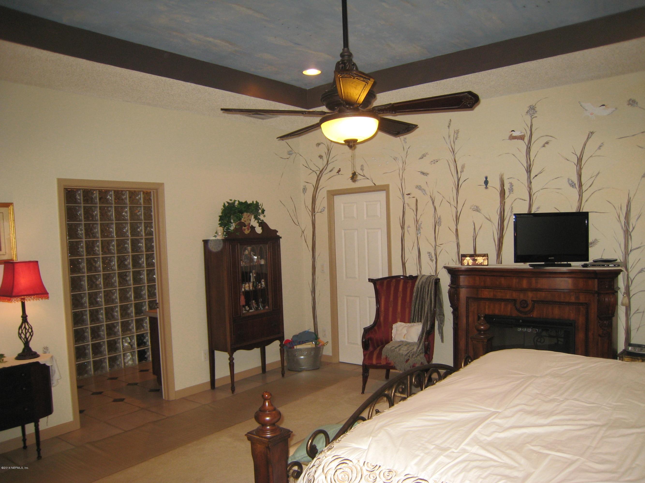11636 Mandarin Road Jacksonville, FL 32223 - Photo 20 of 41 a bedroom with a bed and a television