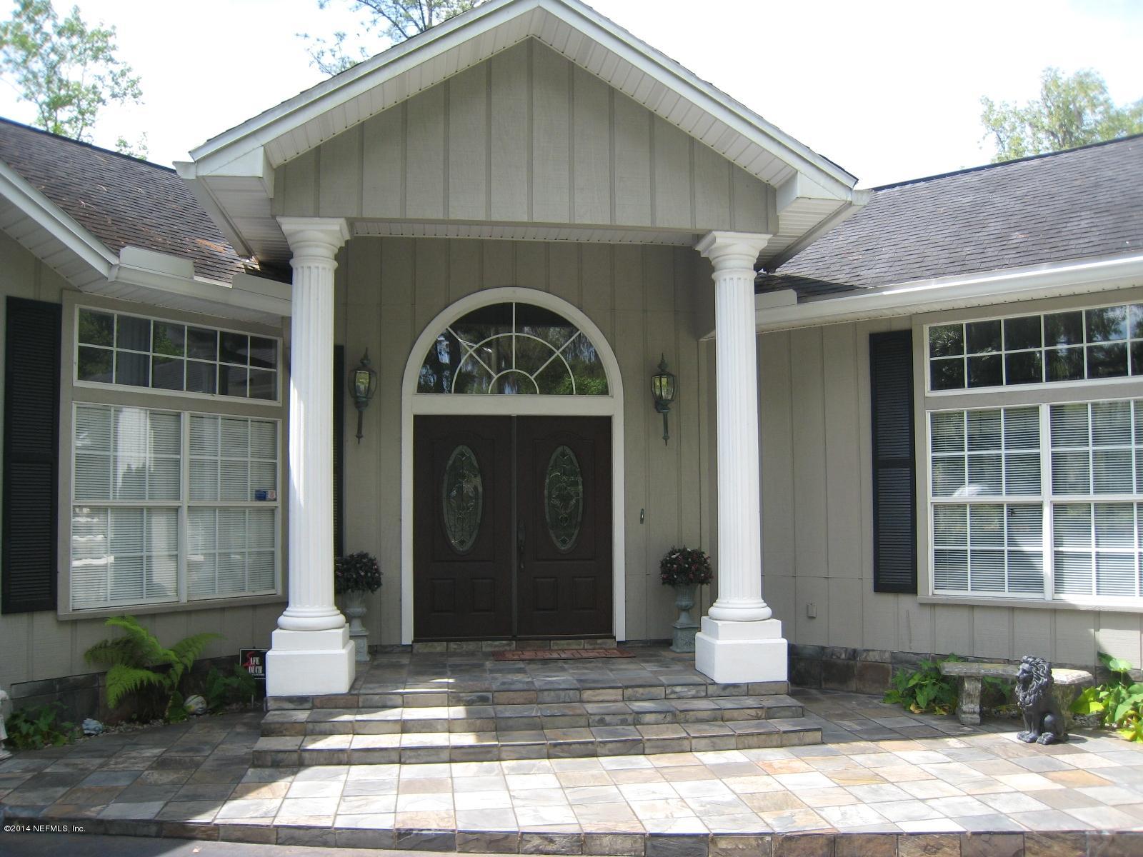 11636 Mandarin Road Jacksonville, FL 32223 - Photo 2 of 41 a front view of a house with a yard