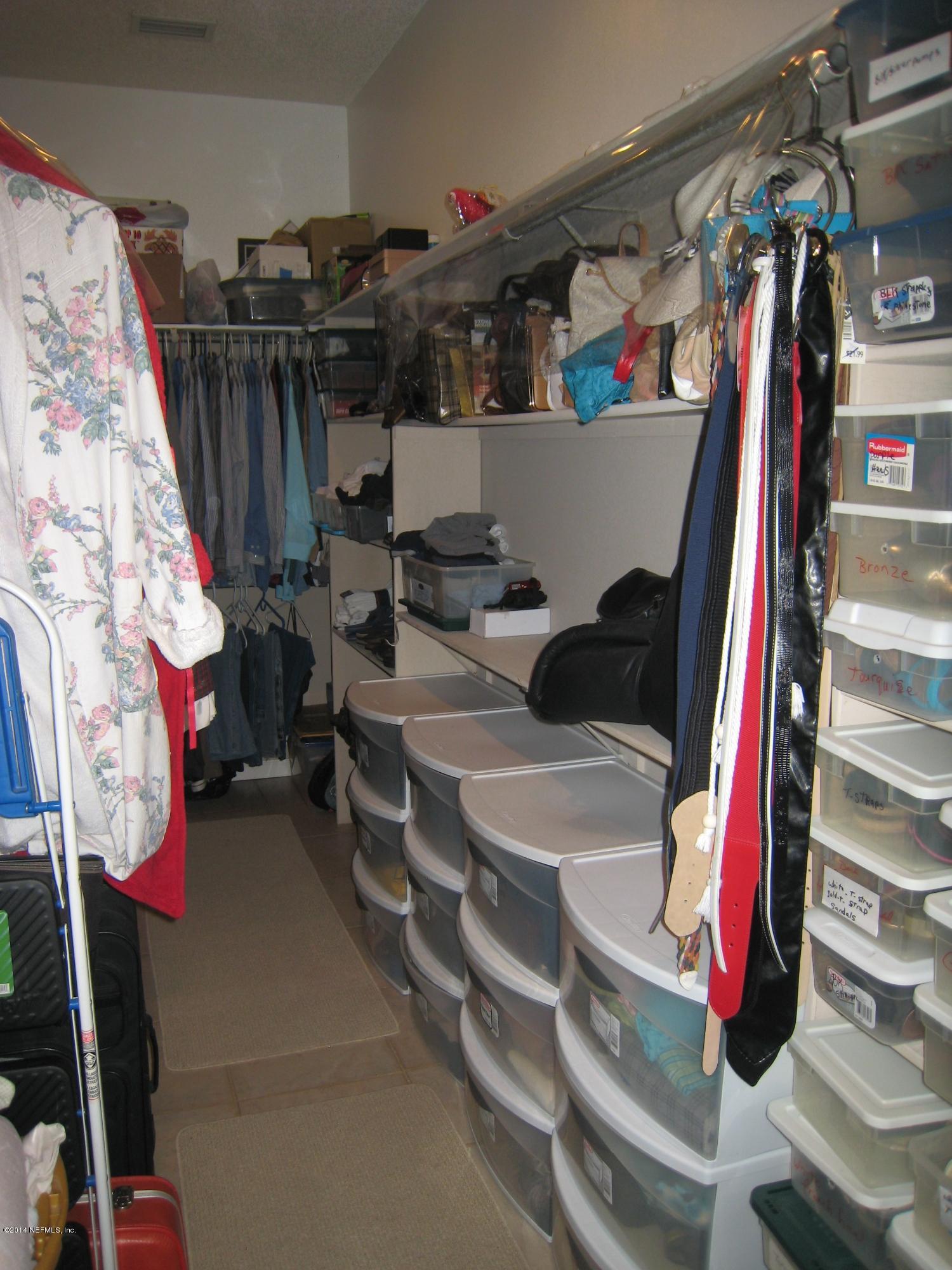 11636 Mandarin Road Jacksonville, FL 32223 - Photo 21 of 41 a view of walk in closet with clothes and shoes