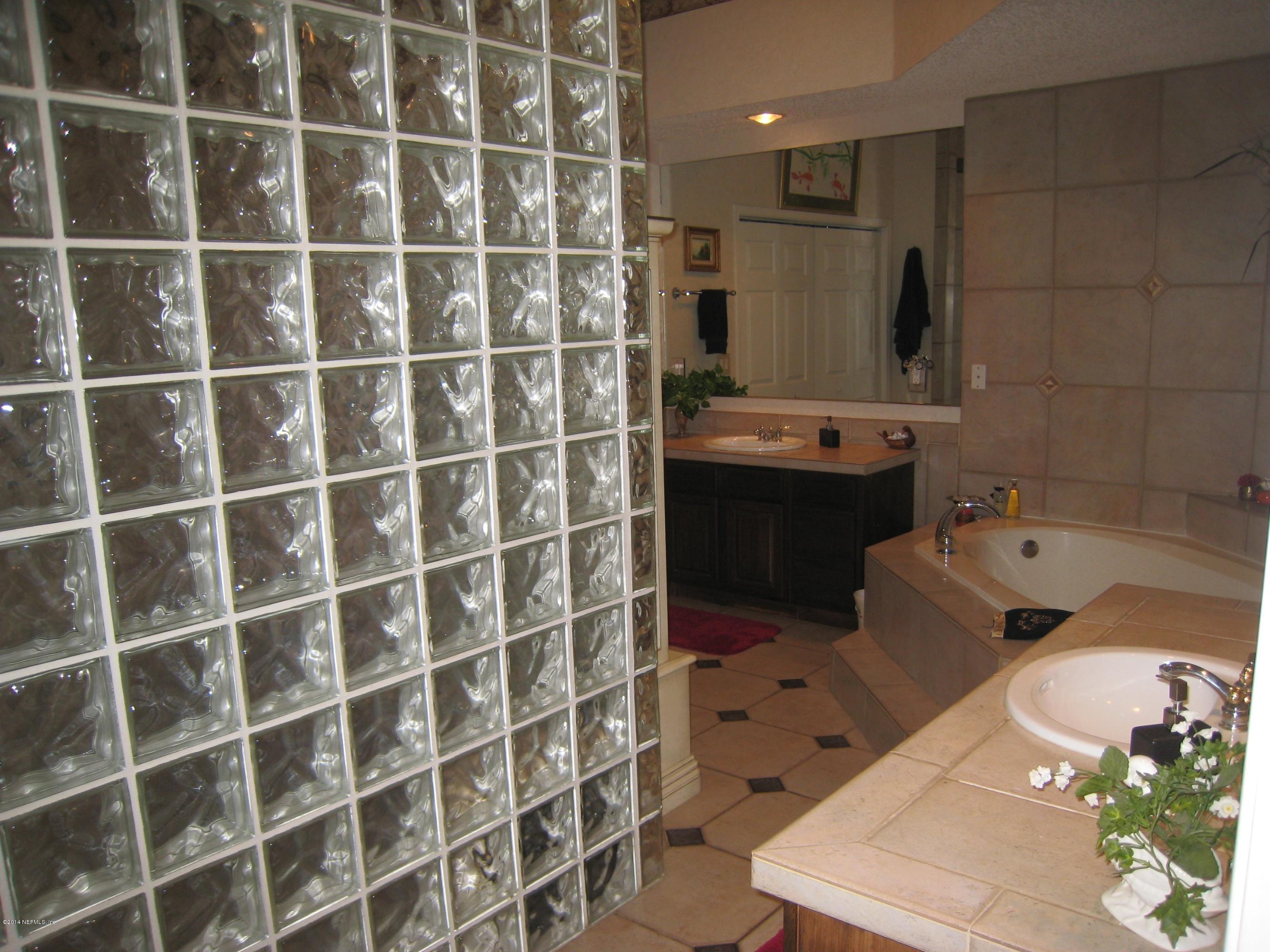 11636 Mandarin Road Jacksonville, FL 32223 - Photo 22 of 41 a bathroom with a double vanity sink mirror and shower