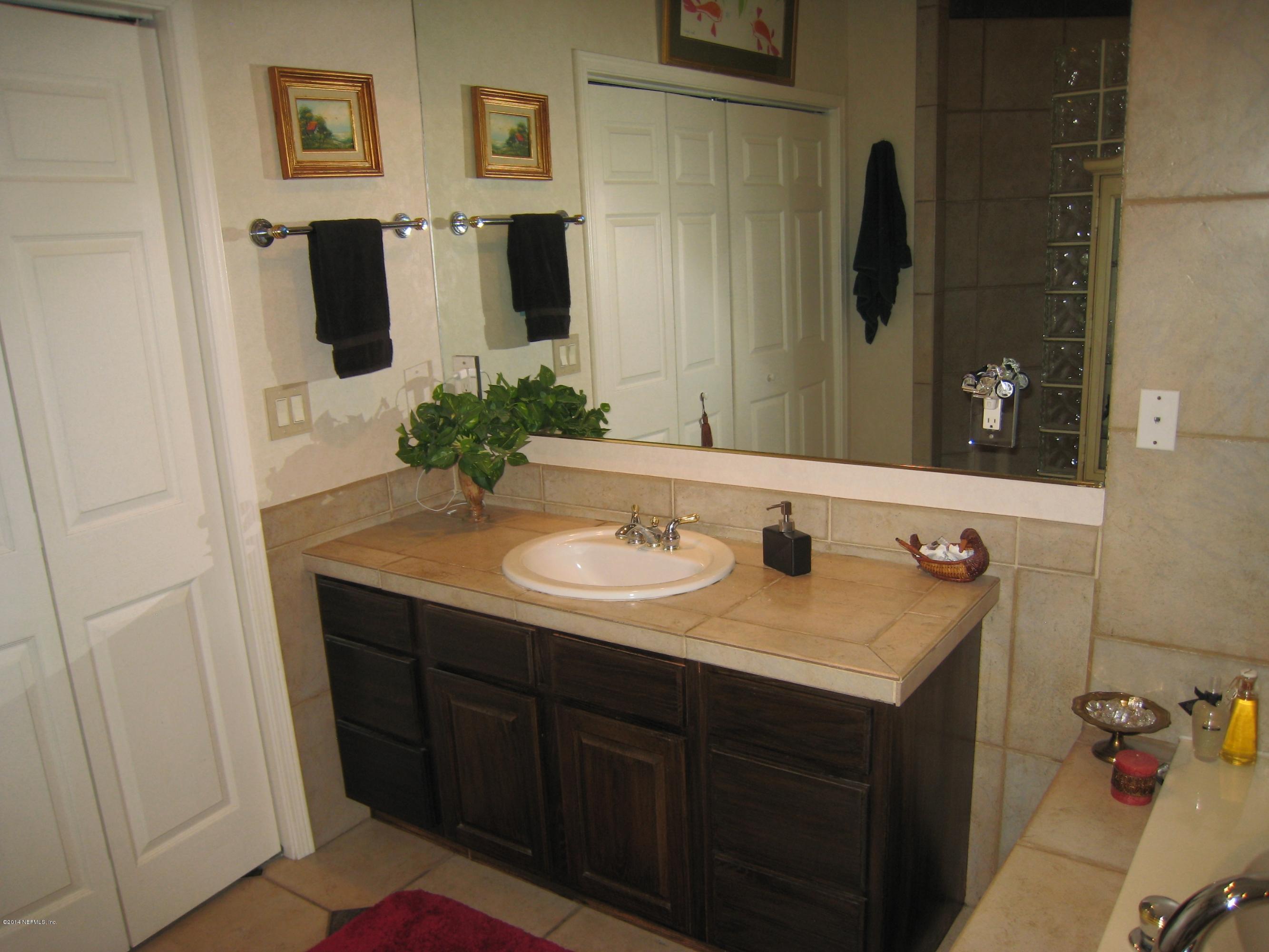11636 Mandarin Road Jacksonville, FL 32223 - Photo 24 of 41 a bathroom with a sink and a mirror