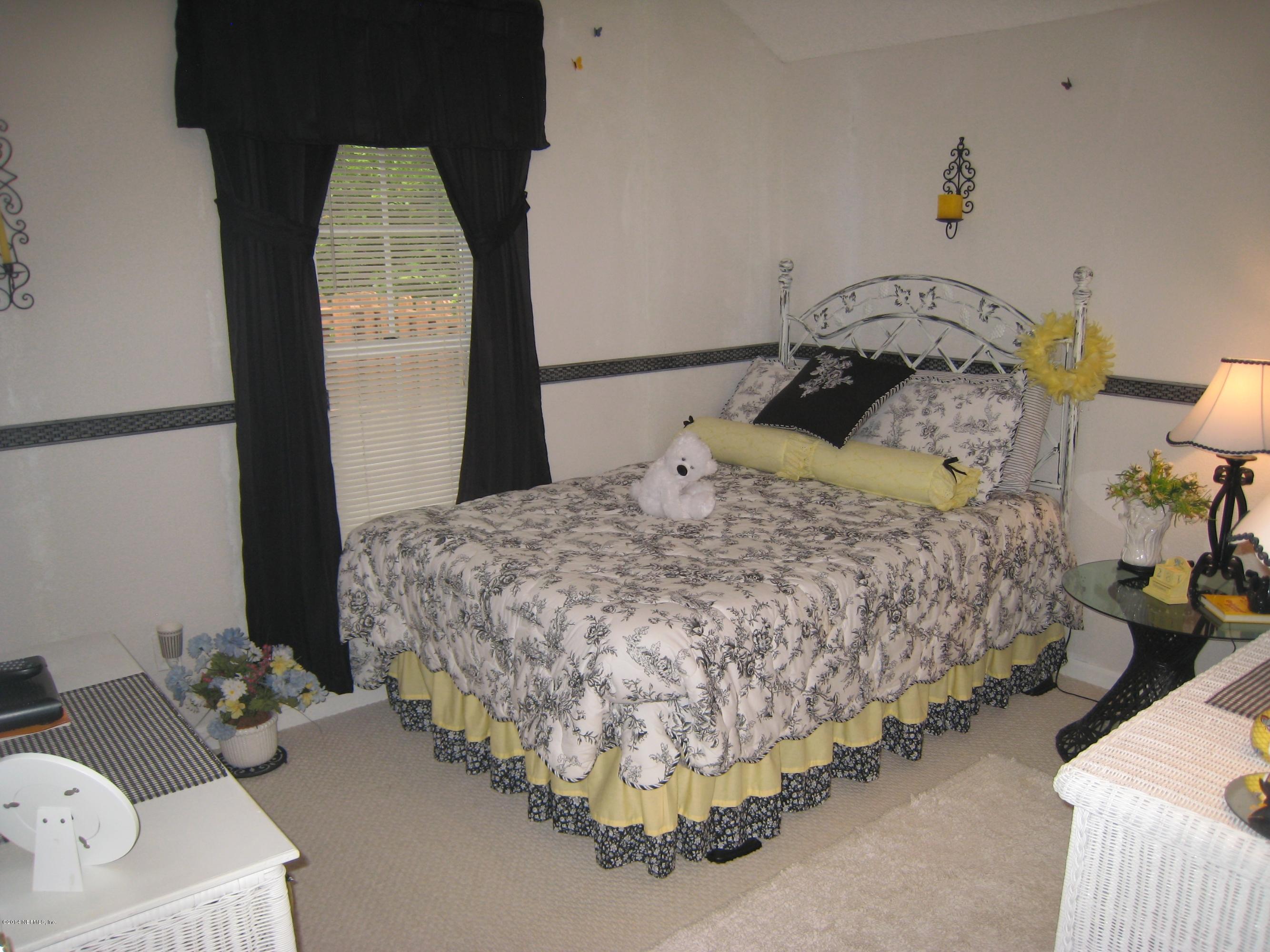 11636 Mandarin Road Jacksonville, FL 32223 - Photo 26 of 41 a bedroom with a bed and a dresser