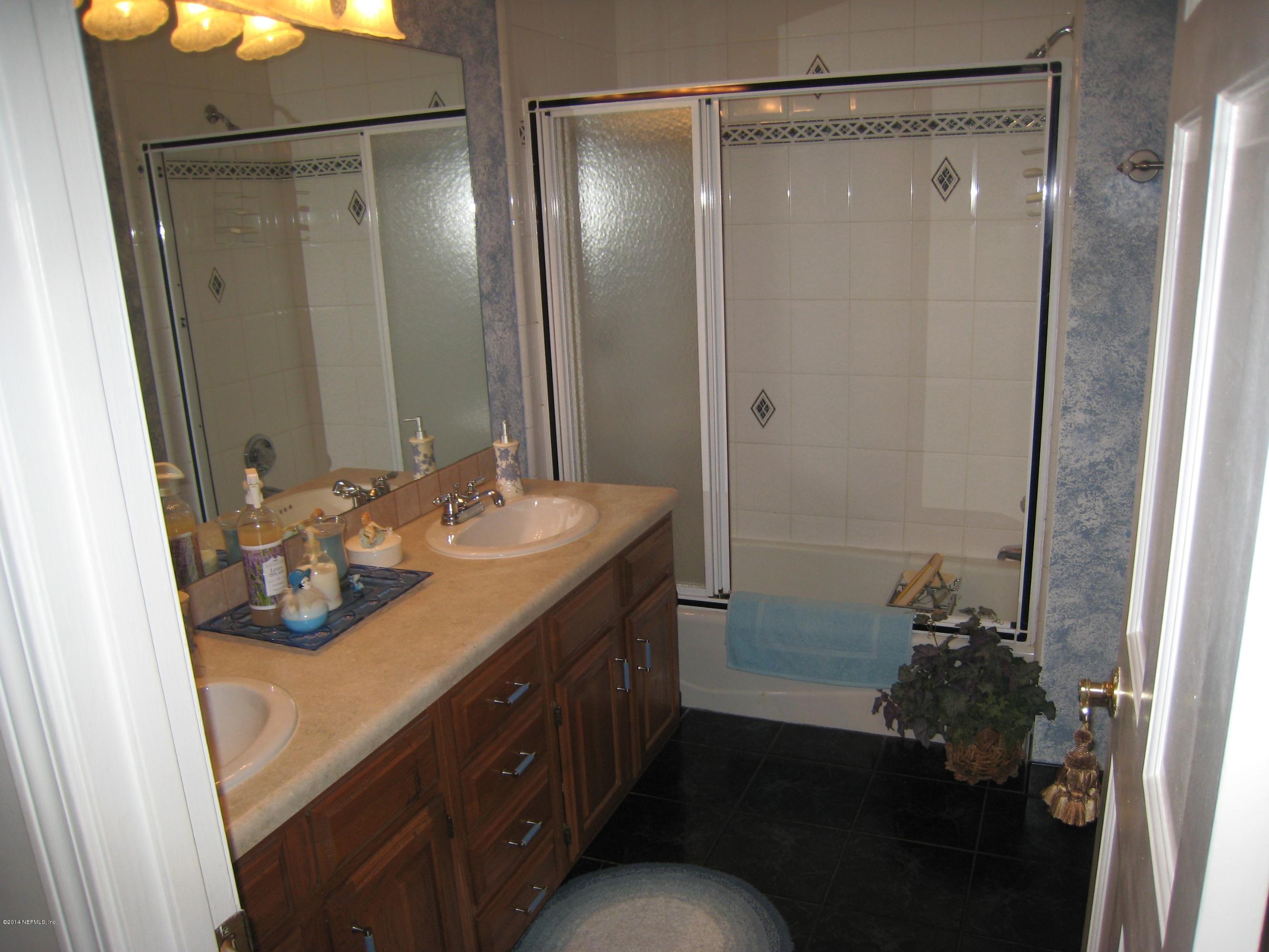 11636 Mandarin Road Jacksonville, FL 32223 - Photo 27 of 41 a bathroom with a sink mirror and shower