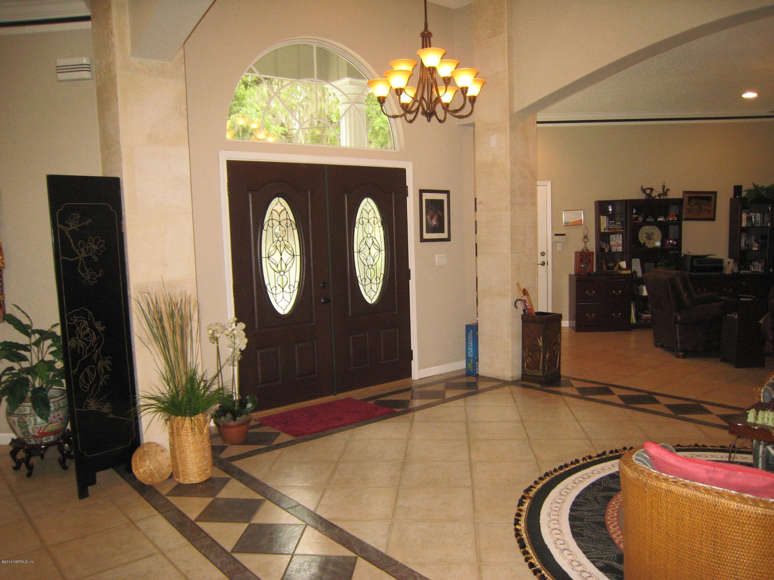 11636 Mandarin Road Jacksonville, FL 32223 - Photo 3 of 41 a room with chandelier fan and view of kitchen