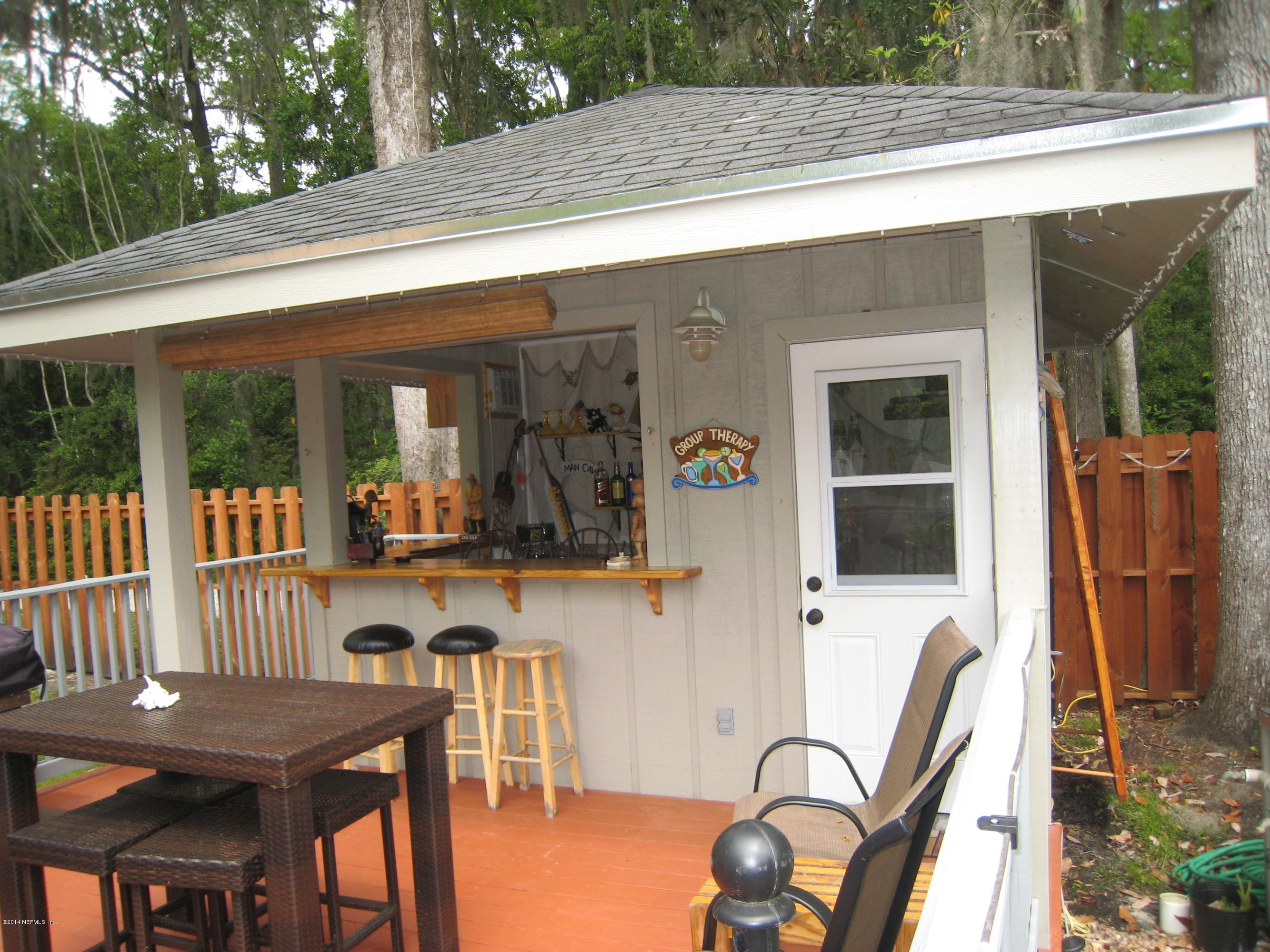 11636 Mandarin Road Jacksonville, FL 32223 - Photo 32 of 41 a view of a patio filled with furniture and porch