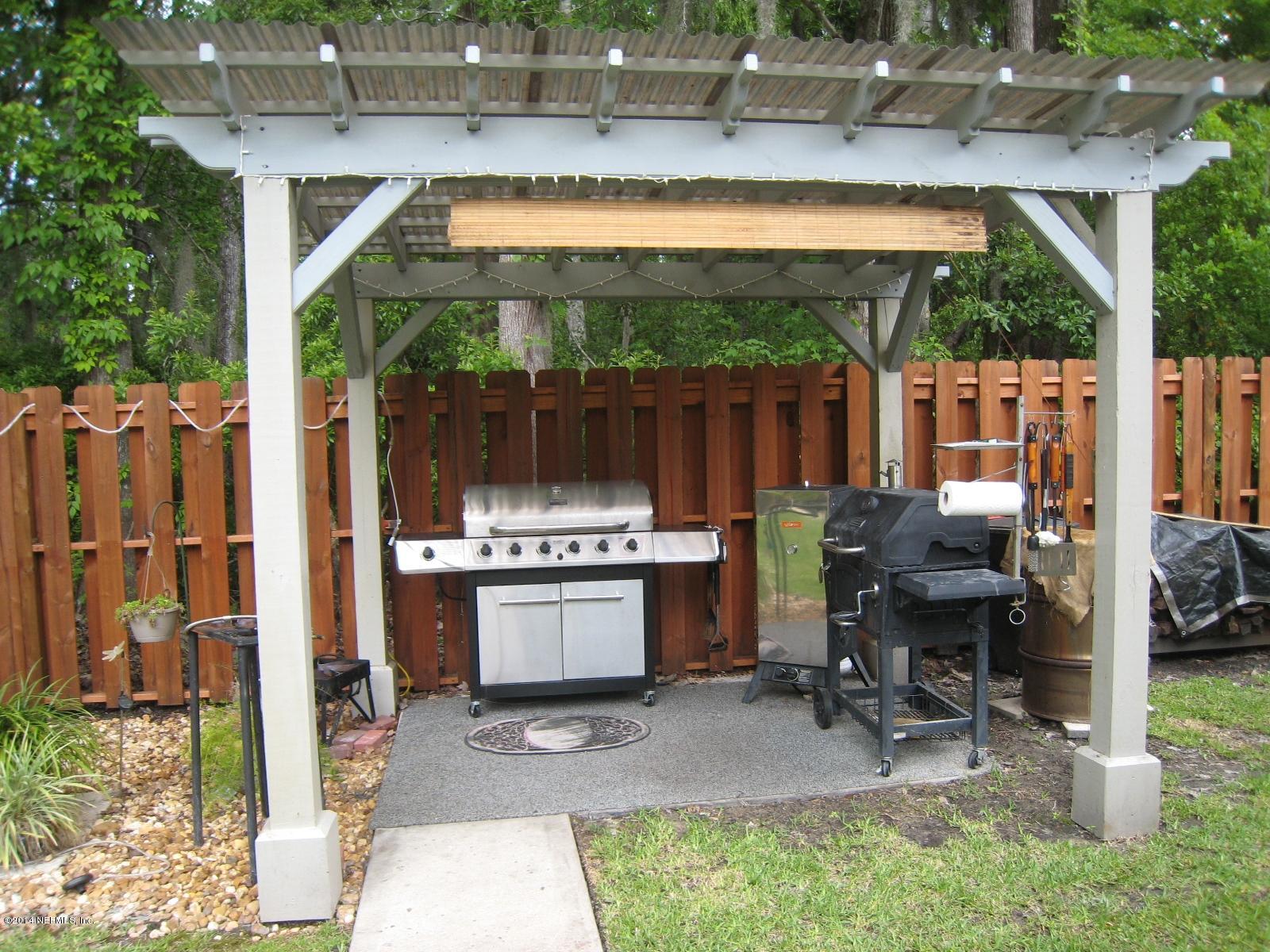 11636 Mandarin Road Jacksonville, FL 32223 - Photo 37 of 41 a backyard of a house with yard and outdoor seating