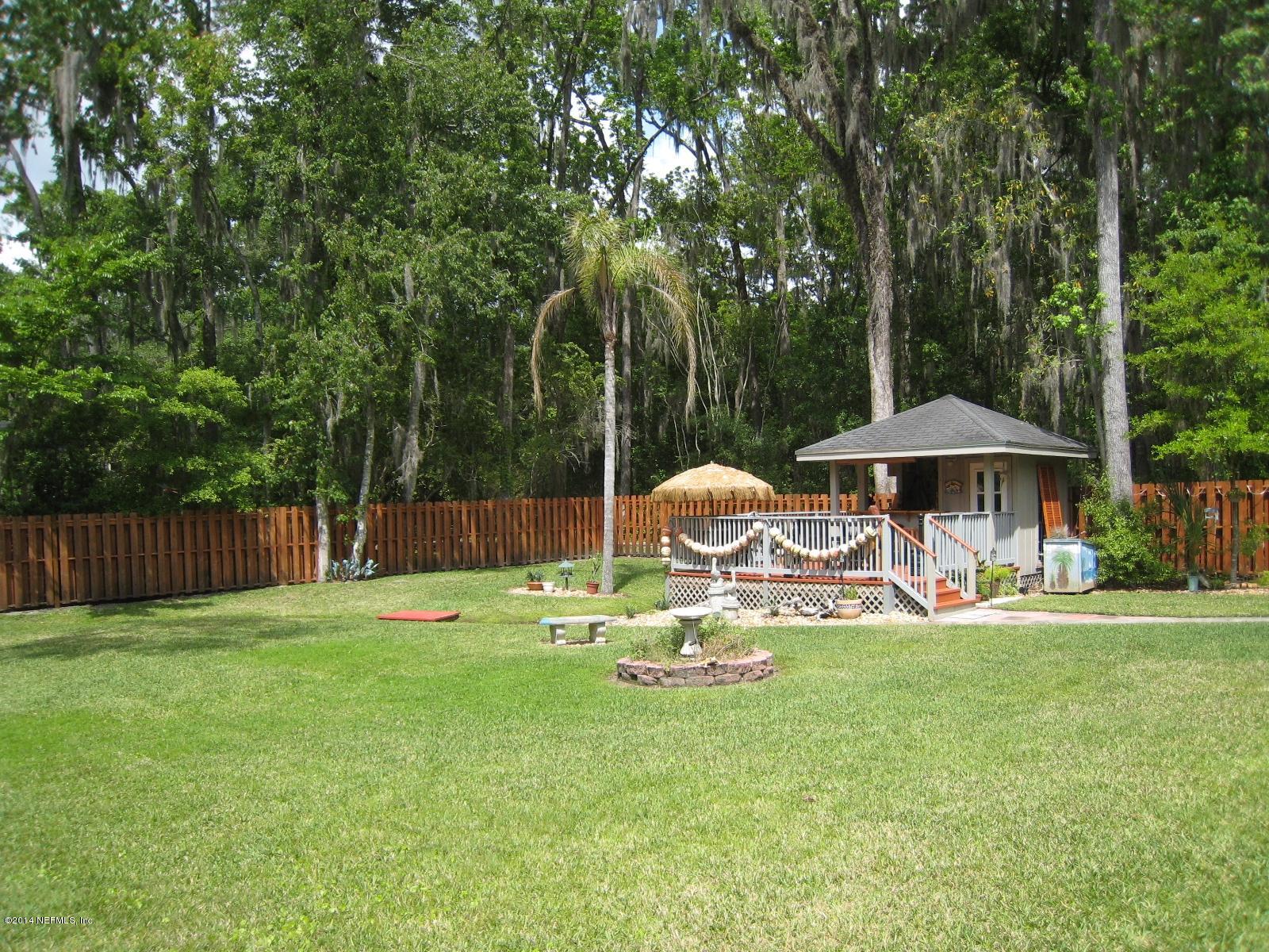 11636 Mandarin Road Jacksonville, FL 32223 - Photo 40 of 41 a backyard of a house with table and chairs
