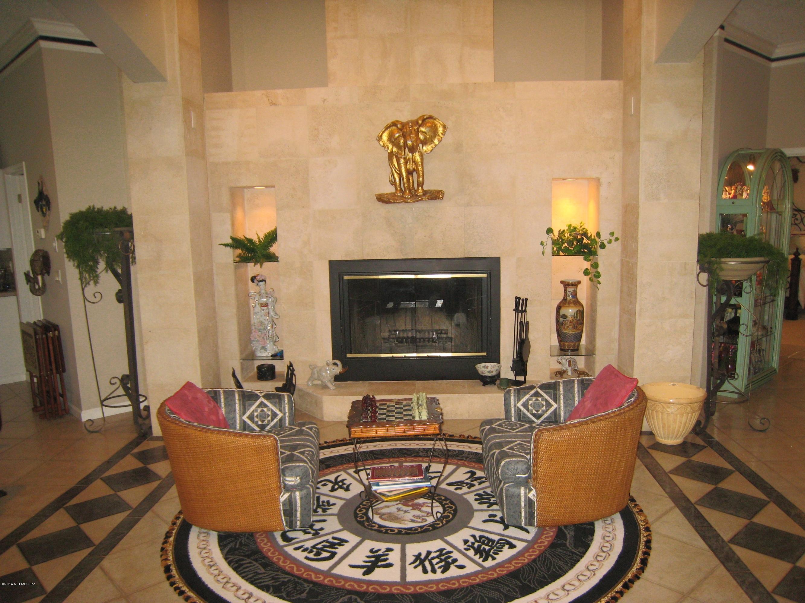 11636 Mandarin Road Jacksonville, FL 32223 - Photo 6 of 41 a living room with furniture and a fireplace