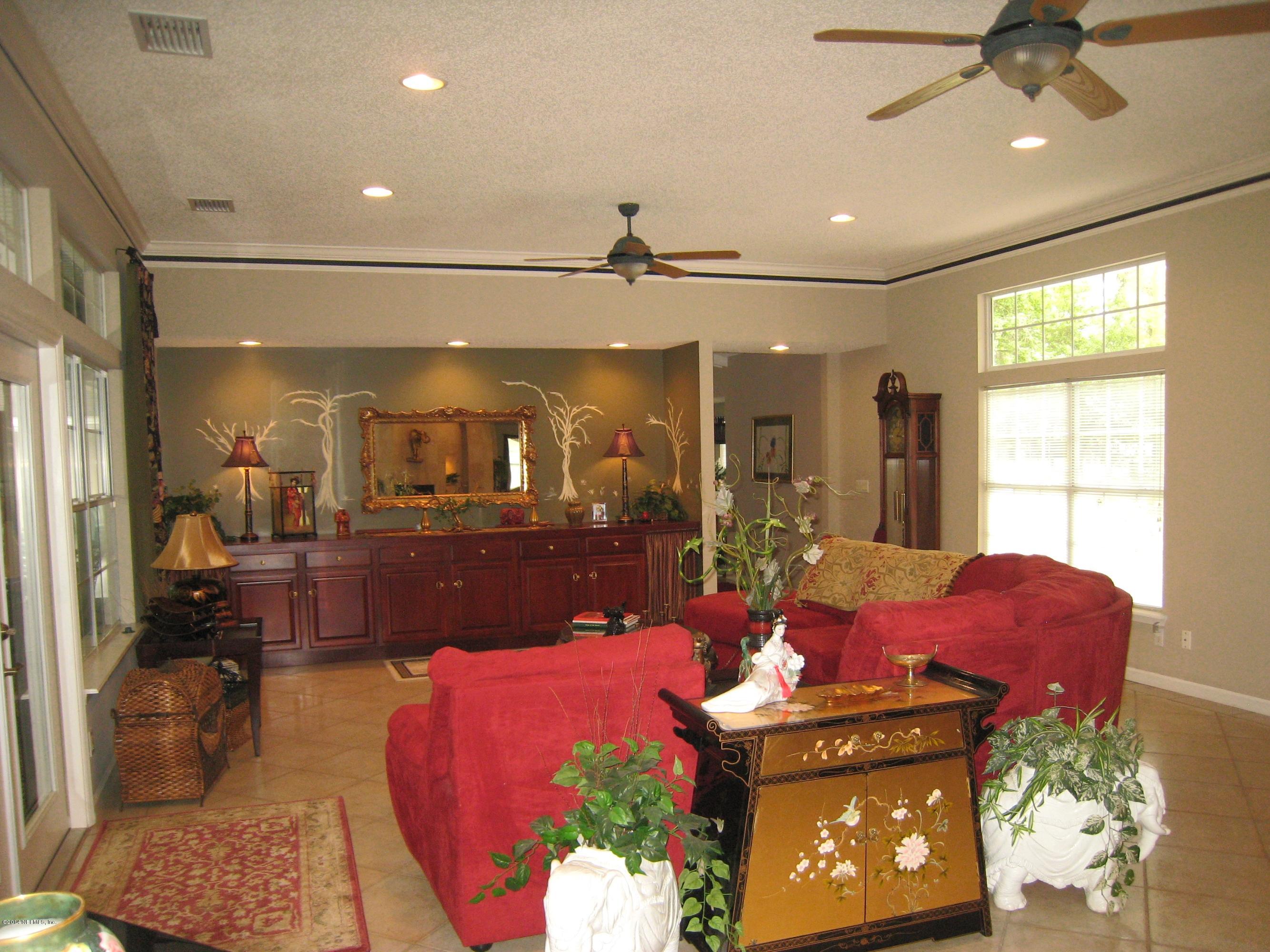 11636 Mandarin Road Jacksonville, FL 32223 - Photo 7 of 41 a living room with furniture and a chandelier