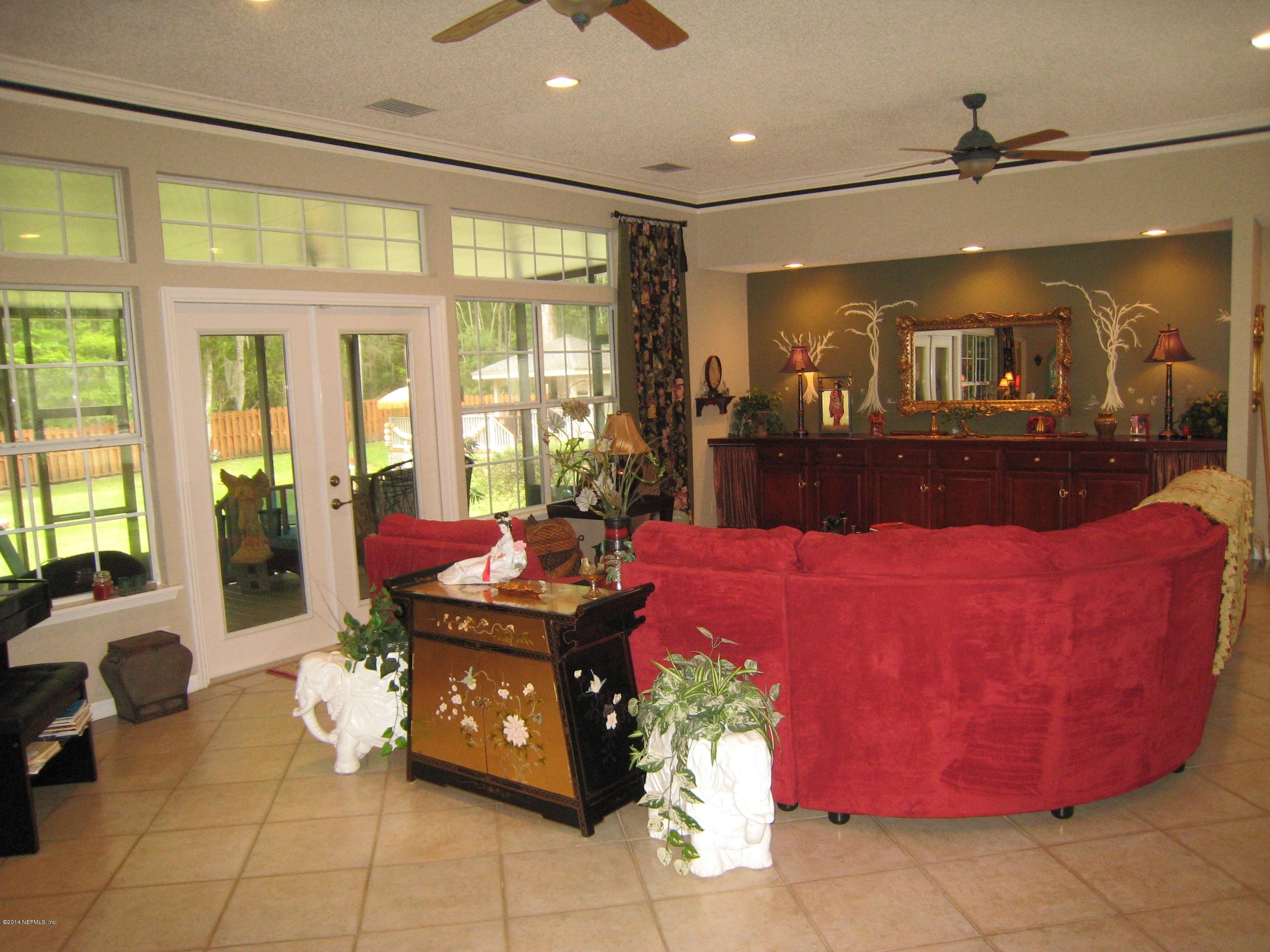 11636 Mandarin Road Jacksonville, FL 32223 - Photo 10 of 41 a living room with furniture and a floor to ceiling window