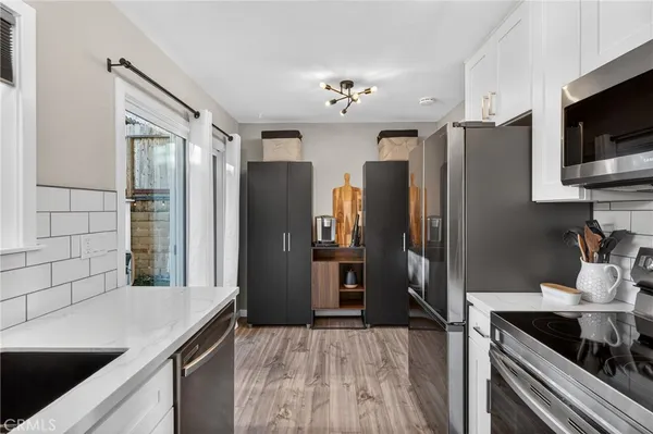 a kitchen with granite countertop a refrigerator and a sink