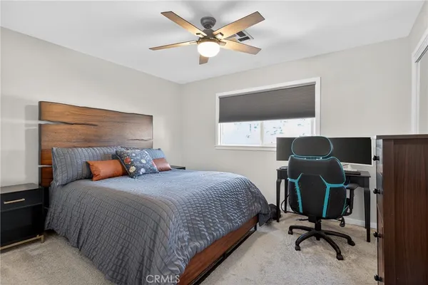 a bedroom with a bed a desk and chair