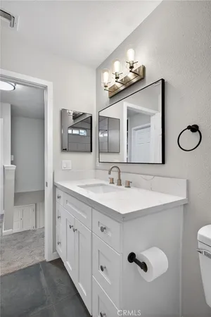 a bathroom with a double vanity sink mirror and toilet