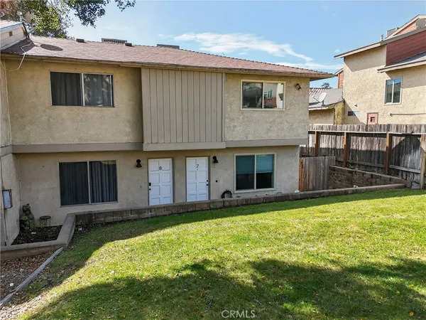 a large white house with a large pool in front of it