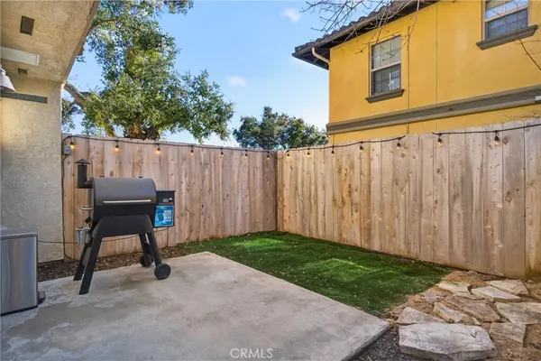 a backyard of a house with table and chairs