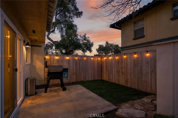 a backyard of a house with table and chairs
