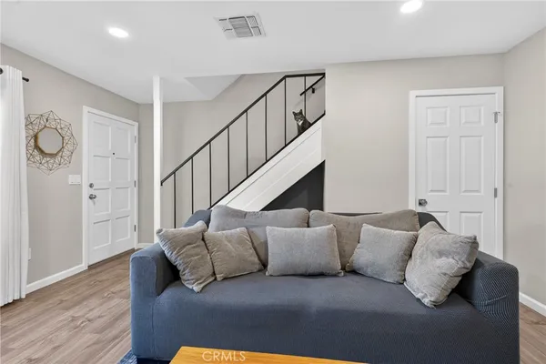 a living room with furniture and stairs