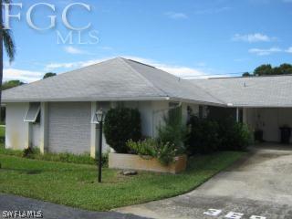 369 Westpark Road Lehigh Acres, FL 33936 - Photo 1 of 7 a front view of a house with garden